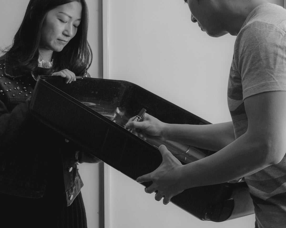 A quality control check taking place, with a worker inspecting a Monos suitcase shell.