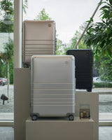 The Hybrid collection displayed on pedestals in a modern indoor setting with a large window and greenery outside.