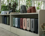 The Classic collection and Metro collection displayed on built-in shelving in a bright, modern retail space with large windows and greenery.