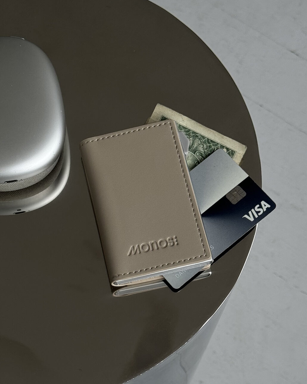 A Slim Wallet Pro in Ivory / Brushed Silver on top of a table