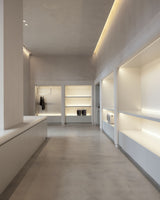 Modern interior with light-colored walls and ceiling, featuring built-in shelves and a coat rack.