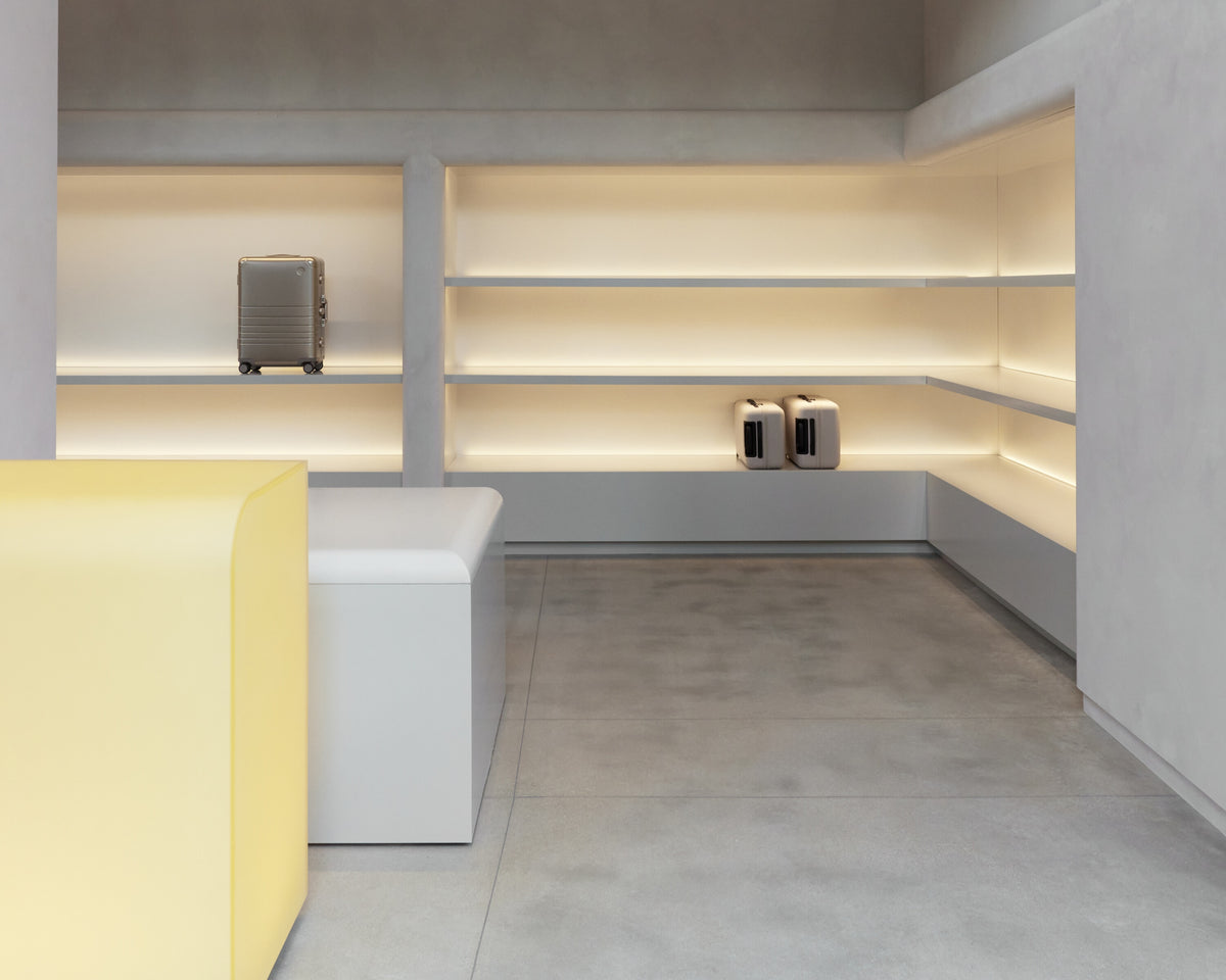 Modern interior design with shelves, a yellow bench, and a gray floor.