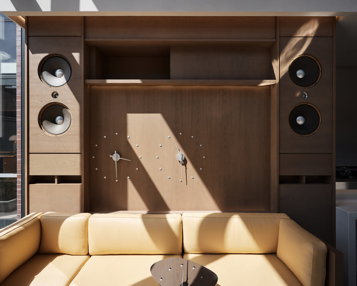 Modern living room with wooden entertainment center and yellow sofa